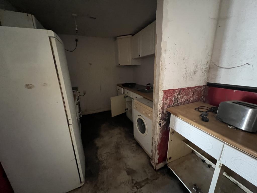 Lot: 112 - MAISONETTE FOR IMPROVEMENT - General view of the ground floor kitchen area